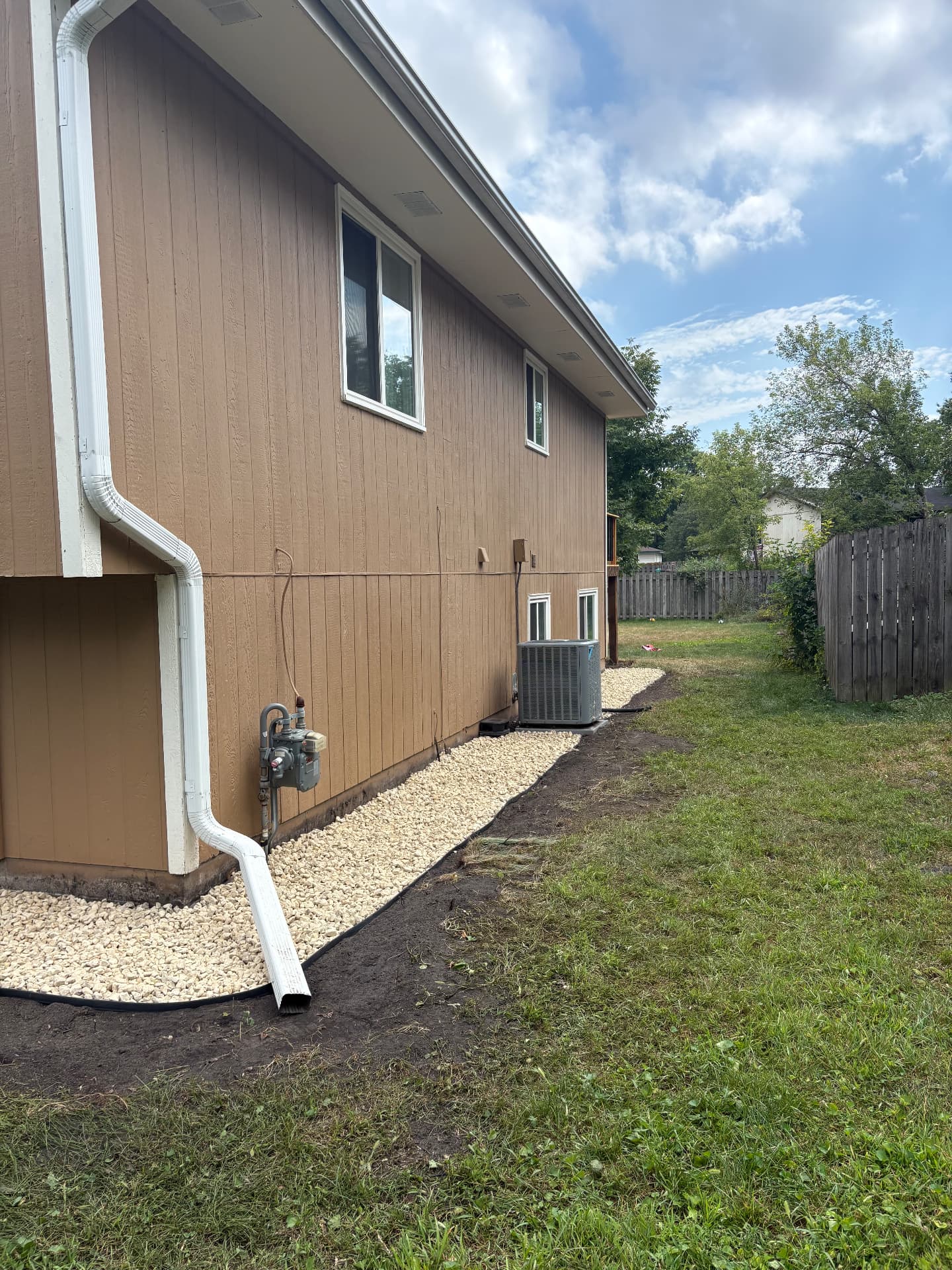 Landscaping • Rock Installation — Same yard after rock installation and cleanup